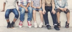 Five children sitting on a bench